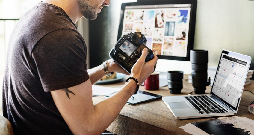 Artist looking at settings on a digital camera